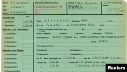 The 1941 military service record of SS soldier Hans Lipschis is shown in this undated handout photograph provided by the Muzeum Auschwitz-Birkenau. 