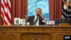 FILE - An official White House photograph released on September 27, 2013, shows President Barack Obama talking on the phone in the Oval Office.