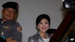 FILE - Thailand's former Prime Minister Yingluck Shinawatra, arrives at parliament in Bangkok, Thailand.