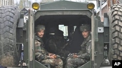 Indian Army soldiers look from inside of an armored vehicle near the site of a gun battle on the outskirts of Srinagar (File 2010)