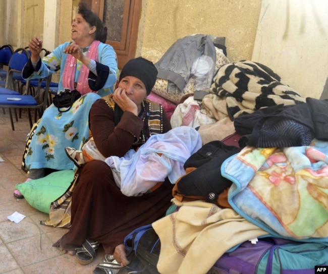 Egyptian Coptic Christians sit in the courtyard of the Evangelical Church in the Suez Canal city of Ismailia, Feb. 24, 2017, upon arriving to take refuge from Islamic State jihadists.