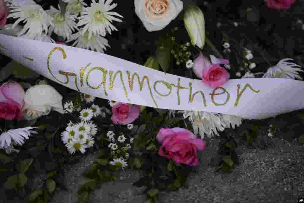 Flowers and a banner are placed at a makeshift memorial to honor the victims of Wednesday&#39;s shooting rampage, Dec. 5, 2015, in San Bernardino, Calif.