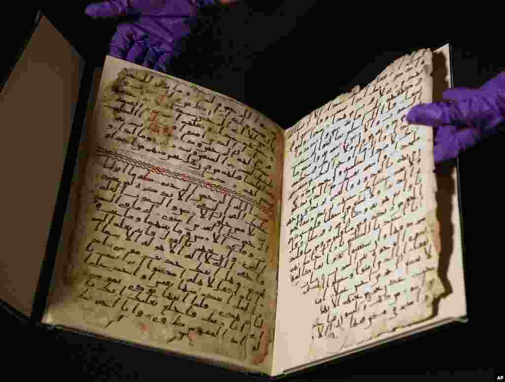 A university assistant shows fragments of an old Quran at the University of Birmingham, in central England. The University of Birmingham said that scientific tests prove a Quran manuscript may have been written close to the time of the Prophet Muhammad. Radiocarbon testing at Oxford University dated the parchment to the time of the prophet, who is generally believed to have lived between 570 and 632.