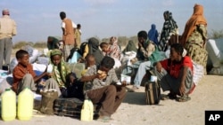 FILE - Somali refugees wait for a plane to take them home from Dabaab refugee camp in northern Kenya.