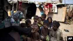 A Pakistani health worker administers polio vaccine to children in a slum of Rawalpindi, Pakistan.