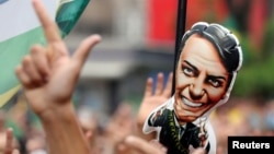 FILE - Supporters of Brazilian presidential candidate Jair Bolsonaro rally in Sao Paulo, Brazil, Sept. 30, 2018.