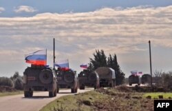 An image grab taken from AFP TV, Jan. 17, 2019, shows Russian army vehicles on patrol in the area of Arimah, just west of Manbij, the northern city near the Turkish border.