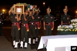 FILE - Coffins containing bodies of Indian soldiers who were killed in an attack at the Indian army base in Kashmir arrive at the Netaji Subhas Chandra Bose International Airport in Kolkata, India, Sept. 19, 2016.