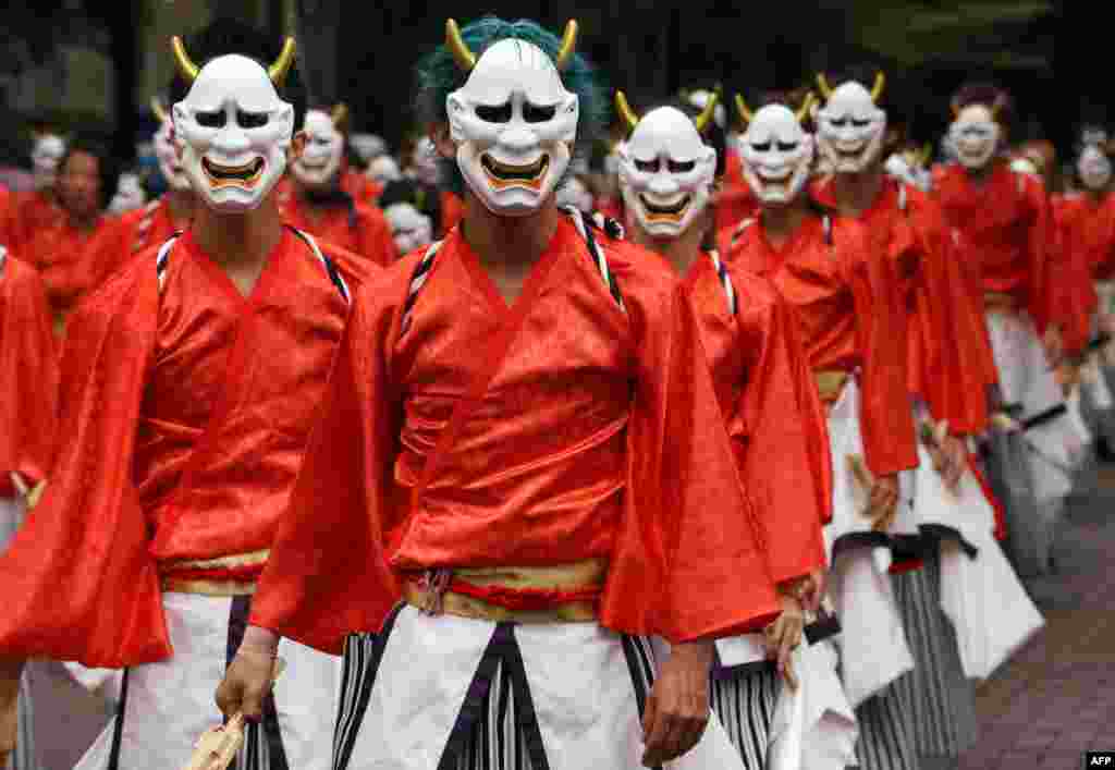 Dancers wearing masks and kimonos perform in the streets at the &quot;Super Yosakoi 2015&quot; dance festival in Tokyo, Japan.