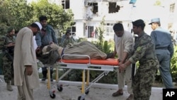 An Afghan security guard, who was wounded in a suicide bombing, is taken to the hospital for treatment, in Kandahar, Afghanistan, October 31, 2011.