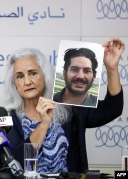 Debra Tice, mother of U.S. journalist Austin Tice, who was kidnapped in Syria five years ago, holds a dated portrait of him during a press conference in Beirut, Lebanon, July 20, 2017.