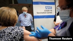 British Prime Minister Boris Johnson visits Guy's Hospital on the first day of administering a coronavirus vaccine in London, Dec. 8, 2020.