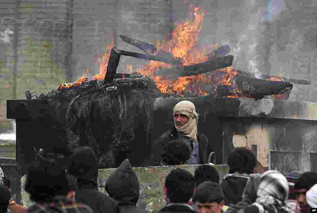 Afghans protest outside the U.S. military base in Bagram, north of Kabul February 21, 2012, after a report that foreign troops had improperly disposed of copies of the Quran and other religious items. (REUTERS)