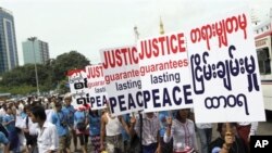 Participants march to mark the International Day of Peace in downtown Yangon, Myanmar, Friday, Sept. 21, 2012. They pray for a cease-fire in the long-running ethnic insurgency in their Kachin State. (AP Photo/Khin Maung Win)