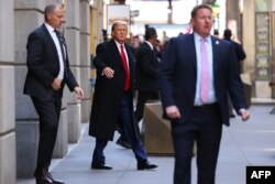 Former U.S. President Donald Trump departs 40 Wall Street after holding a news conference following a court hearing about his trial for allegedly covering up hush money payments linked to extramarital affairs, in New York, March 25, 2024.