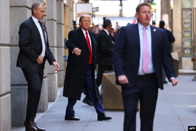 Former U.S. President Donald Trump departs 40 Wall Street after holding a news conference following a court hearing about his trial for allegedly covering up hush money payments linked to extramarital affairs, in New York, March 25, 2024.