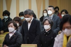 Christian faithful wear masks to prevent contacting coronavirus during a service in Seoul, South Korea, Feb. 23, 2020.
