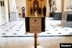 A sign indicating proper social distancing measures is displayed ahead of a vote in the House of Representatives on an additional coronavirus economic stimulus package, on Capitol Hill, April 23, 2020.