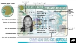 This image released by USCIS shows a sample of the front of the redesigned green card carried by foreign-born residents living permanently in the U.S. The Homeland Security Department is issuing the redesigned "green card" that is stacked with safety