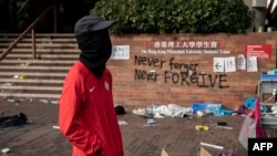 A protester stands inside the Hong Kong Polytechnic University campus where a small group of protesters continue to hold out, in the Hung Hom district in Hong Kong, Nov. 23, 2019.