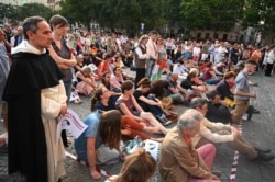 FILE - People pray for Vincent Lambert, who is in a vegetative state since 2008, in Paris on July 10, 2019.