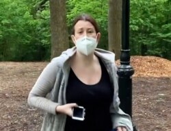 FILE - This image made from May 25, 2020 video provided by Christian Cooper, shows Amy Cooper with her dog talking to Christian Cooper in Central Park in New York.