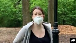 FILE - This image made from May 25, 2020 video provided by Christian Cooper, shows Amy Cooper with her dog talking to Christian Cooper in Central Park in New York.