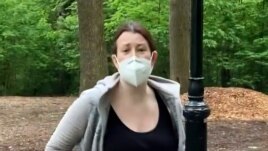 FILE - This image made from May 25, 2020 video provided by Christian Cooper, shows Amy Cooper with her dog talking to Christian Cooper in Central Park in New York.