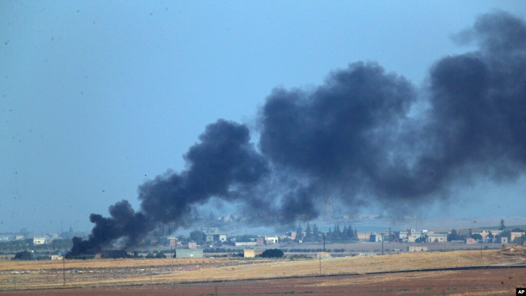  In this photo taken from the Turkish side of the border between Turkey and Syria, in Akcakale, Sanliurfa province, southeastern Turkey, smoke billows from a fire inside Syria during bombardment by Turkish forces Wednesday, Oct. 9, 2019. 