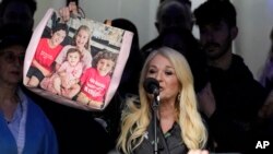 FILE— Vanessa Feltz, English TV personality and broadcaster, holds a bag picturing her grandchildren as Jewish people and sympathizers gather, in London, March 10, 2024,