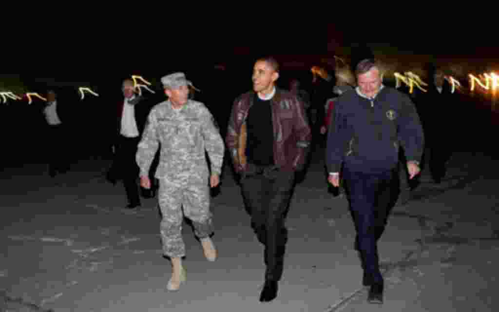 Obama walks with Gen. David Petraeus and U.S. Ambassador Karl Eikenberry after arriving at Bagram Air Field in Afghanistan, Dec. 3, 2010