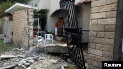 A general view of the damage caused by a bomb blast is seen at the gate of the Iranian ambassador's residence in Tripoli, Libya, Feb. 22, 2015.