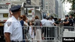 Pedestrians navigate their way through barricades amid heightened security before the start of the United Nations General Assembly in New York City, Sept. 17, 2017. 