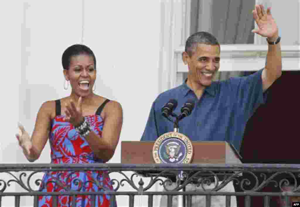 President Barack Obama and first lady Michelle Obama welcome military families to an Independence Day celebration on the South Lawn of the White House in Washington, Monday, July 4, 2011. (AP Photo/Charles Dharapak)