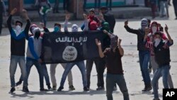 Para demonstran Muslim Kashmir memegang bendera ISIS saat melakukan protes anti-India di Srinagar, daerah Kashmir yang dikuasai India, April 2016. (AP/Dar Yasin)