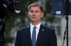 FILE - British Foreign Secretary Jeremy Hunt prepares to give an interview outside his home in London, June 24, 2019.