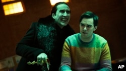 This image released by Universal Pictures shows Nicholas Hoult, right, and Nicolas Cage in a scene from "Renfield."