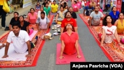 FILE- A yoga class being held in Gurgaon, near New Delhi is one of hundreds of such sessions which are gaining in popularity in India. 