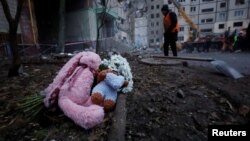 Tributes are left at the site where an apartment block was heavily damaged by a Russian missile strike, amid Russia's attack on Ukraine, in Dnipro, Ukraine Jan. 16, 2023. 