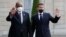 French President Emmanuel Macron, right, welcomes President of the Sudanese Transitional Council General Abdel Fattah al-Burhan, left, for a dinner with leaders of African states, at the Elysee Palace, in Paris, May 17, 2021.