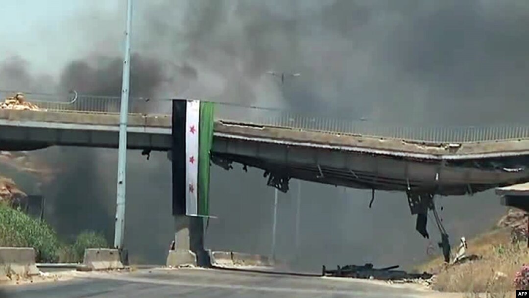 An image grab taken from a video released by the United Nations Supervision Mission in Syria shows smoke rising following shelling from the central flashpoint city of Homs on June 11, 2012. 