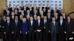 Delegates attending the London Conference on Libya, pose for a group photo at Lancaster House in London, Tuesday March 29, 2011.