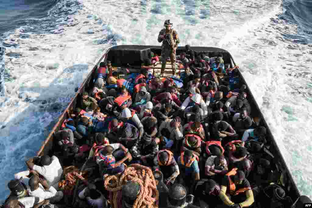 A Libyan coast guardsman stands on a boat during the rescue of 147 illegal immigrants attempting to reach Europe off the coastal town of Zawiyah, 45 kilometers west of the capital Tripoli.