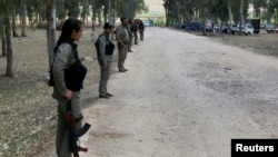 Kurdish Democratic Union Party (PYD) members stand guard during a Labour Day celebration in Efrin May 1, 2014.