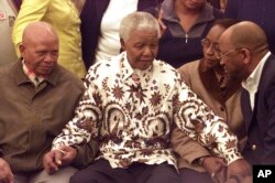 FILE - Former South African President Nelson Mandela wears a printed shirt in Johannesburg, on July 18, 2003 as part of his 85th birthday celebrations.