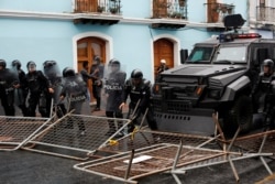 Riot police move barricades set up by demonstrators during a protest after Ecuadorian President Lenin Moreno's government ended four-decade-old fuel subsidies, in Quito, Ecuador, Oct. 3, 2019.