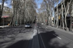 Cars drive in Vali-e-Asr St., which usually has congested traffic, in northern Tehran, Iran, March 20, 2020.