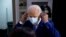 Democratic presidential candidate former Vice President Joe Biden removes his face mask as he arrives to speak at the Hotel DuPont in Wilmington, Del., Aug. 13, 2020. 