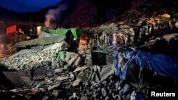 Rescuers work at the site of a landslide near Torkham border, Pakistan April 18, 2023.