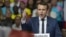 Supporters of French presidential candidate Emmanuel Macron hold placards as he speaks during a campagin rally in Lyon, central France, Feb. 4, 2017.